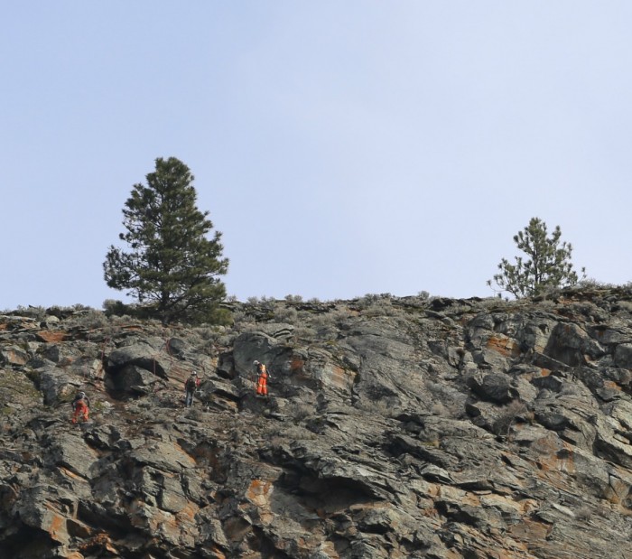 three scalers tethered to the top of the cliff