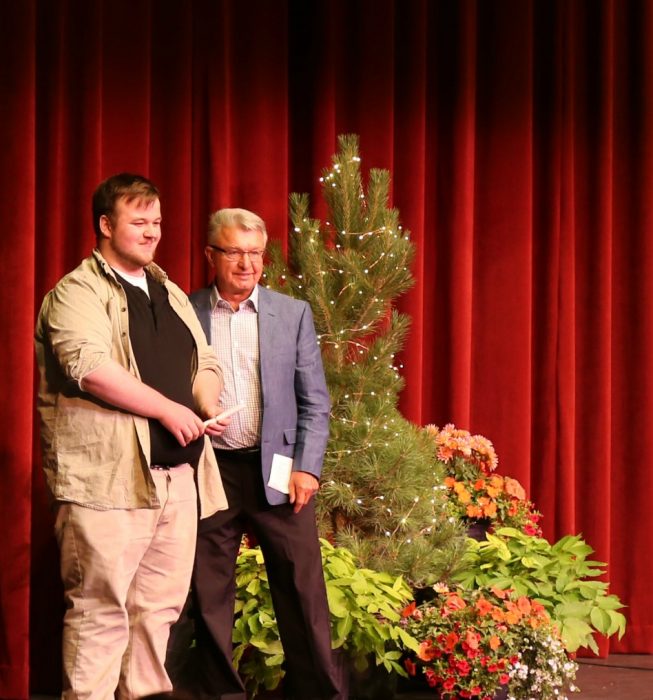 Brodie Becker receives award from Trustee Sam Hancheroff