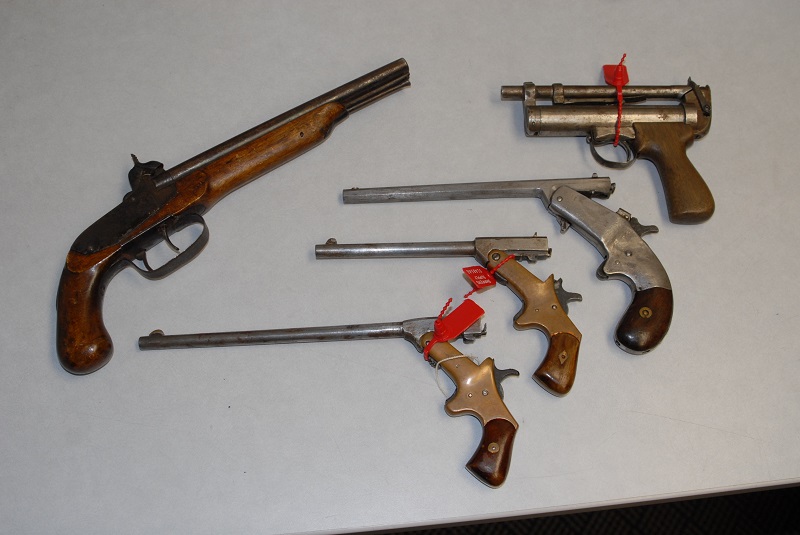 Five pistols turned into the Kelowna RCMP during the amnesty, three of the firearms .22 calibre pistols (centred in the photo) were said to be hand made during the early war period. The pistol in the upper right side of the photo is an air pistol, while the other was a musket hand gun.