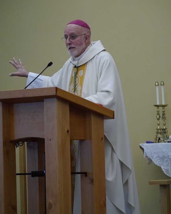 Bishop John Corriveau delivers a homily from the new lectern.