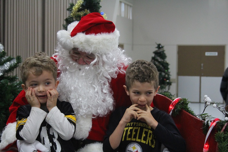 Brody Anderson, on left, and brother Braylon visit with Santa.